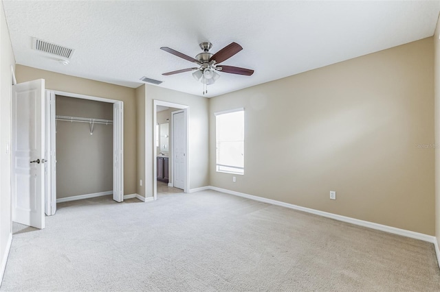 7184 Maleberry Run, Winter Garden, FL 34787 - unfurnished bedroom featuring light colored carpet, a closet, a ceiling fan, and ensuite bathroom