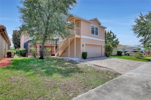 7184 Maleberry Run, Winter Garden, FL 34787 - view of front of property with stucco siding, stairway, a garage, decorative driveway, and a front yard