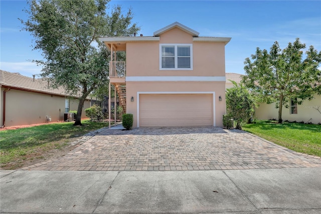 7184 Maleberry Run, Winter Garden, FL 34787 - view of front of property featuring decorative driveway, stucco siding, a garage, a front yard, and a balcony