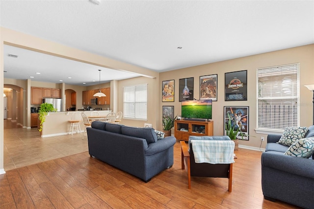 12868 Holdenbury Ln, Windermere, FL 34786 - living room with arched walkways and light wood finished floors