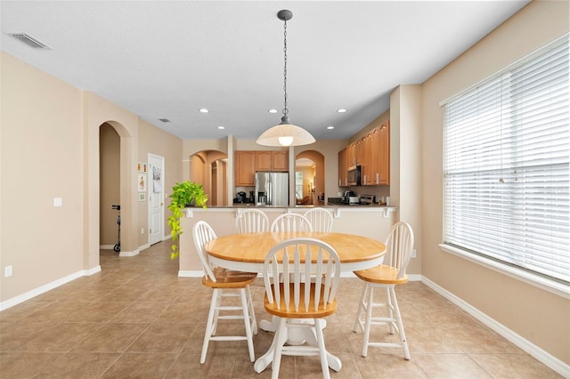 12868 Holdenbury Ln, Windermere, FL 34786 - dining area with arched walkways, plenty of natural light, recessed lighting, and light tile patterned floors