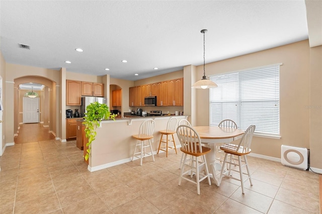 12868 Holdenbury Ln, Windermere, FL 34786 - dining area featuring arched walkways, recessed lighting, and light tile patterned flooring