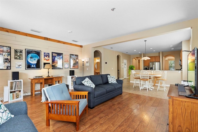 12868 Holdenbury Ln, Windermere, FL 34786 - living room featuring arched walkways and light wood-type flooring