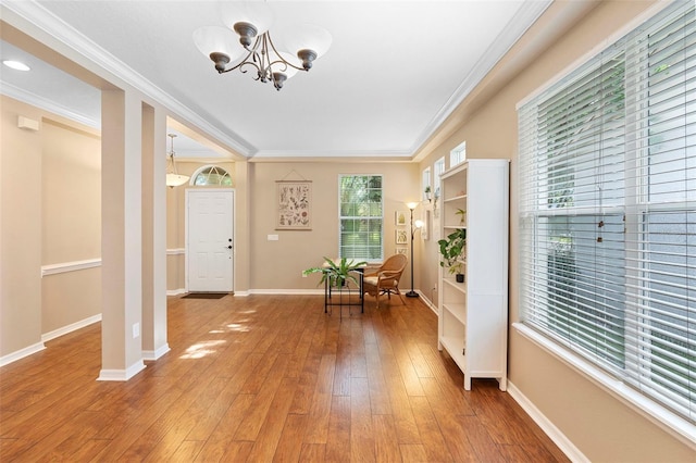 12868 Holdenbury Ln, Windermere, FL 34786 - entrance foyer with a chandelier, crown molding, and light wood-type flooring