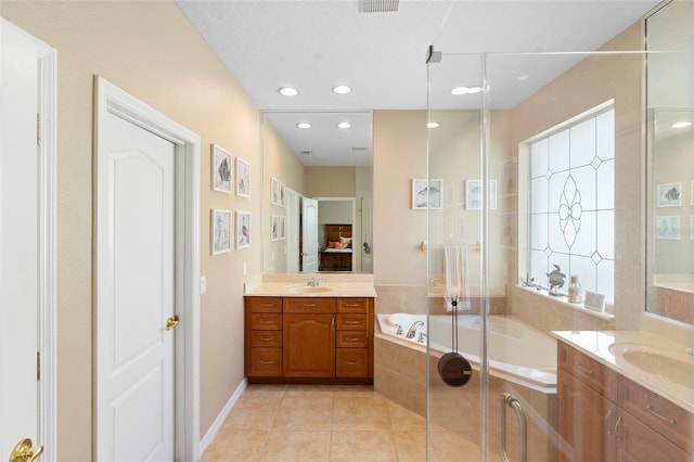 12868 Holdenbury Ln, Windermere, FL 34786 - full bath featuring a garden tub, two vanities, tile patterned flooring, connected bathroom, and recessed lighting