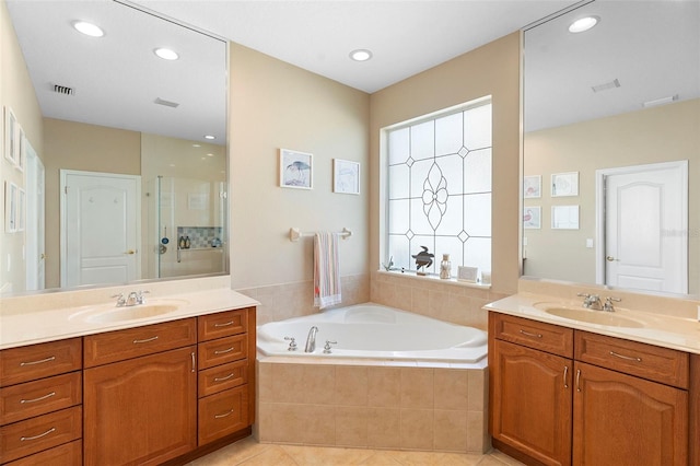12868 Holdenbury Ln, Windermere, FL 34786 - bathroom with two vanities, a bath, plenty of natural light, and recessed lighting
