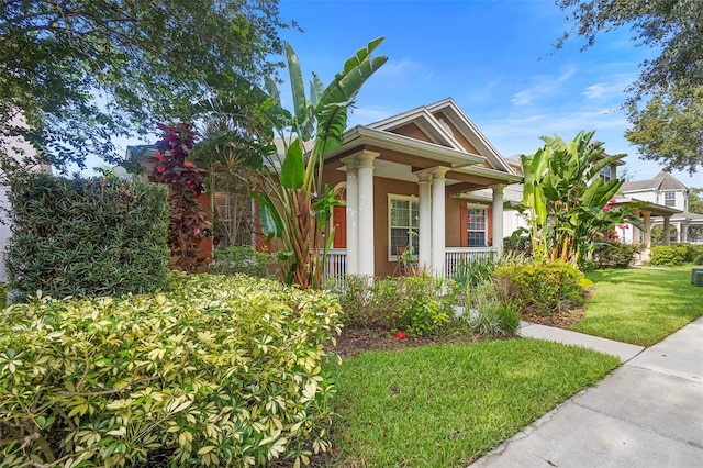 12868 Holdenbury Ln, Windermere, FL 34786 - view of front of house with covered porch, stucco siding, and a front yard