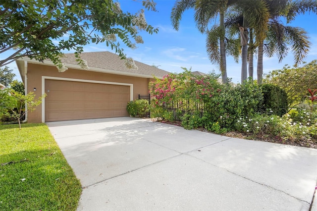 12868 Holdenbury Ln, Windermere, FL 34786 - obstructed view of property with stucco siding, concrete driveway, and a garage