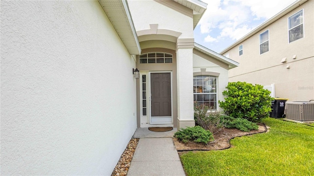 131 Sonja Cir, Davenport, FL 33897 - doorway to property featuring stucco siding and a yard