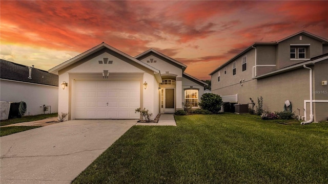 131 Sonja Cir, Davenport, FL 33897 - view of front of property with driveway, stucco siding, a lawn, and an attached garage