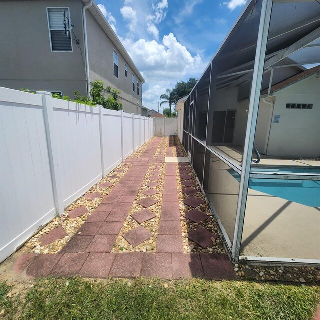 131 Sonja Cir, Davenport, FL 33897 - view of side of property with a fenced backyard, a lanai, and a patio