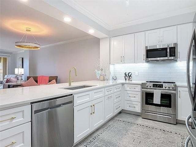 60 Surfview Dr Unit 308, Palm Coast, FL 32137 - kitchen featuring appliances with stainless steel finishes, crown molding, light countertops, decorative backsplash, and white cabinets
