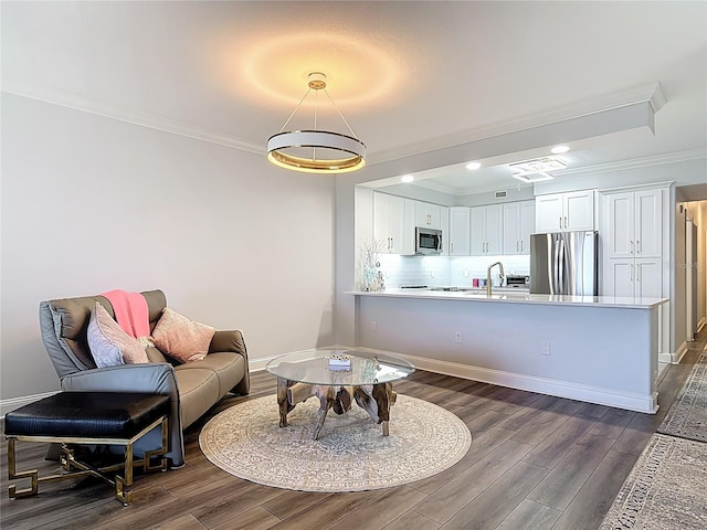 60 Surfview Dr Unit 308, Palm Coast, FL 32137 - living room featuring ornamental molding, dark wood finished floors, and recessed lighting