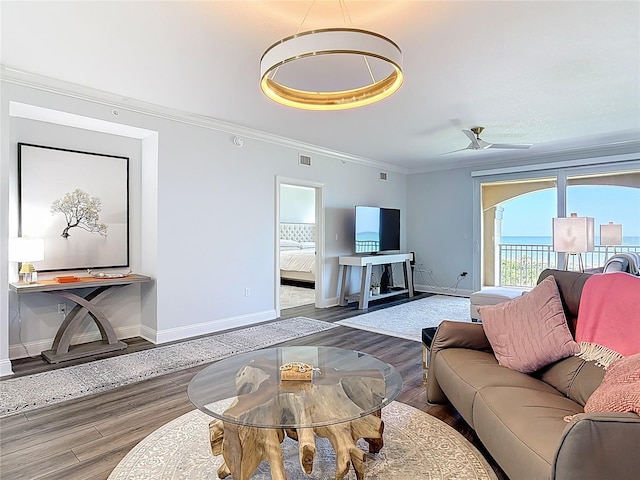 60 Surfview Dr Unit 308, Palm Coast, FL 32137 - living area featuring wood finished floors, crown molding, and ceiling fan