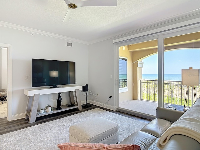 60 Surfview Dr Unit 308, Palm Coast, FL 32137 - living area with ornamental molding, wood finished floors, a ceiling fan, and a textured ceiling
