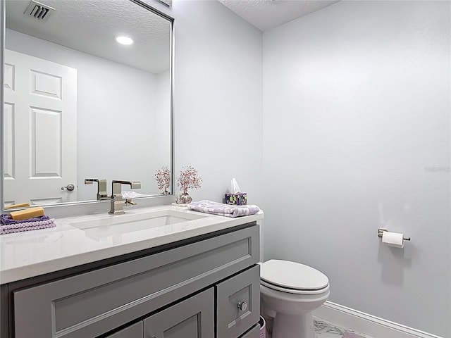 60 Surfview Dr Unit 308, Palm Coast, FL 32137 - half bath featuring marble look tiles, vanity, and a textured ceiling