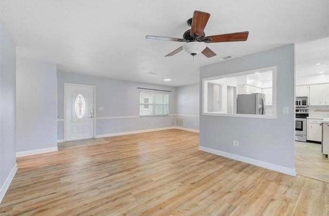 2813 21st Ave W, Bradenton, FL 34205 - unfurnished living room featuring a ceiling fan and light wood finished floors