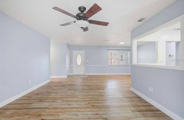 2813 21st Ave W, Bradenton, FL 34205 - unfurnished living room with a ceiling fan and wood finished floors