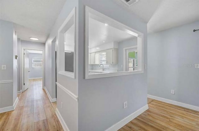 2813 21st Ave W, Bradenton, FL 34205 - corridor with light wood finished floors and plenty of natural light