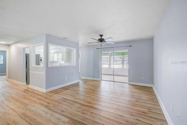 2813 21st Ave W, Bradenton, FL 34205 - spare room with light wood finished floors, a ceiling fan, and a textured ceiling