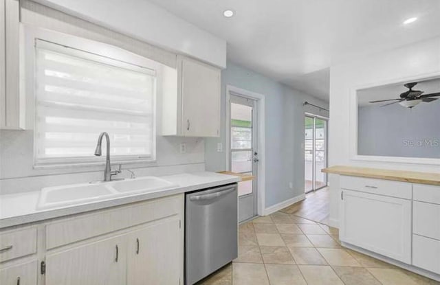 2813 21st Ave W, Bradenton, FL 34205 - kitchen with stainless steel dishwasher, light countertops, ceiling fan, light tile patterned flooring, and white cabinets
