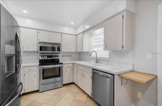 2813 21st Ave W, Bradenton, FL 34205 - kitchen featuring appliances with stainless steel finishes, light countertops, light tile patterned flooring, and recessed lighting
