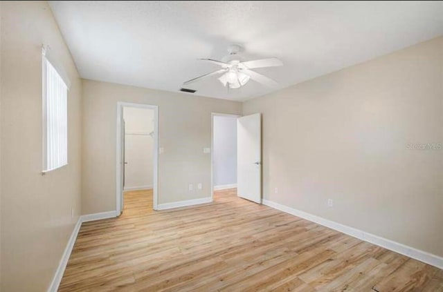 2813 21st Ave W, Bradenton, FL 34205 - unfurnished bedroom featuring light wood-type flooring, a spacious closet, a ceiling fan, and a closet