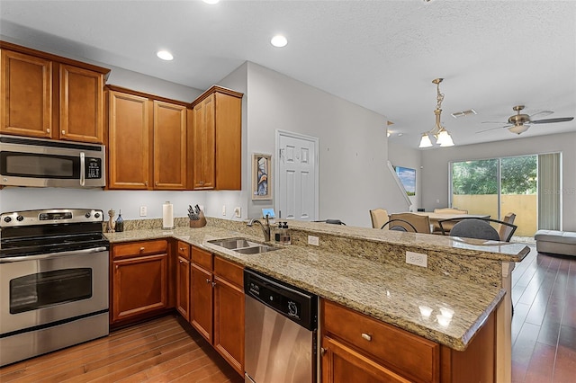 14242 Desert Haven St Unit Ge, Windermere, FL 34786 - kitchen featuring appliances with stainless steel finishes, a peninsula, wood finished floors, a ceiling fan, and recessed lighting