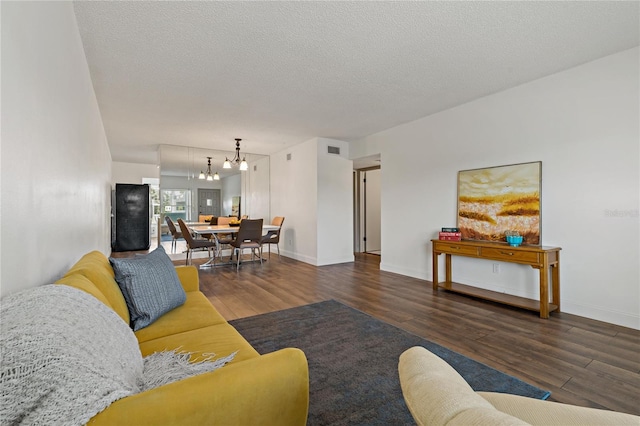 2257 World Parkway Blvd W Unit 61, Clearwater, FL 33763 - living room featuring wood finished floors, a chandelier, and a textured ceiling