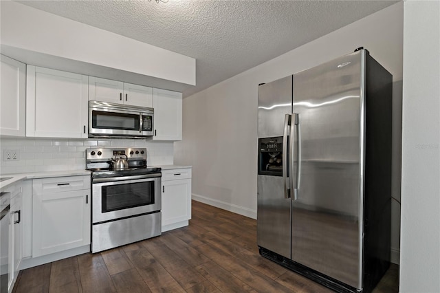 2257 World Parkway Blvd W Unit 61, Clearwater, FL 33763 - kitchen featuring appliances with stainless steel finishes, dark wood-style floors, light countertops, white cabinets, and a textured ceiling