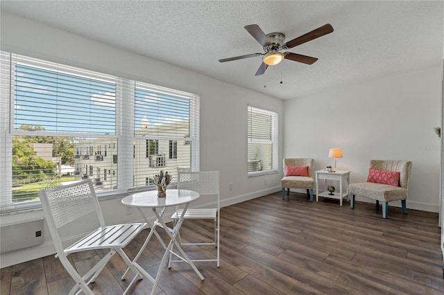 2257 World Parkway Blvd W Unit 61, Clearwater, FL 33763 - sitting room featuring dark wood-type flooring, a textured ceiling, and ceiling fan