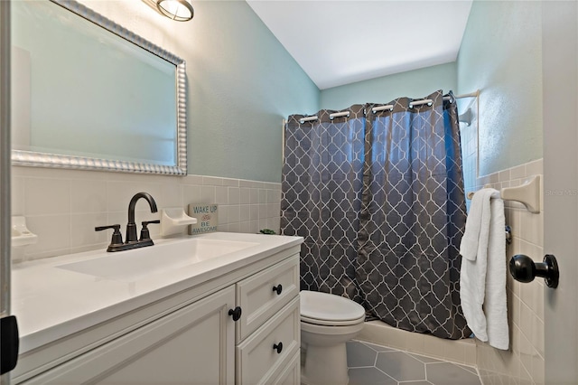 2257 World Parkway Blvd W Unit 61, Clearwater, FL 33763 - bathroom with tile walls, vanity, tile patterned floors, a shower with curtain, and wainscoting