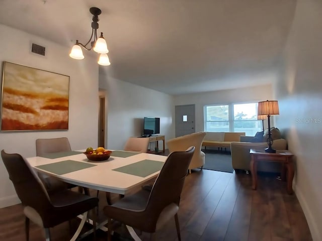 2257 World Parkway Blvd W Unit 61, Clearwater, FL 33763 - dining space with wood finished floors and a chandelier
