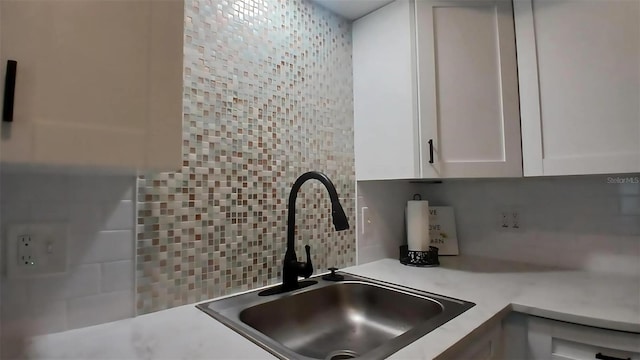 2257 World Parkway Blvd W Unit 61, Clearwater, FL 33763 - kitchen with decorative backsplash, white cabinets, and light countertops