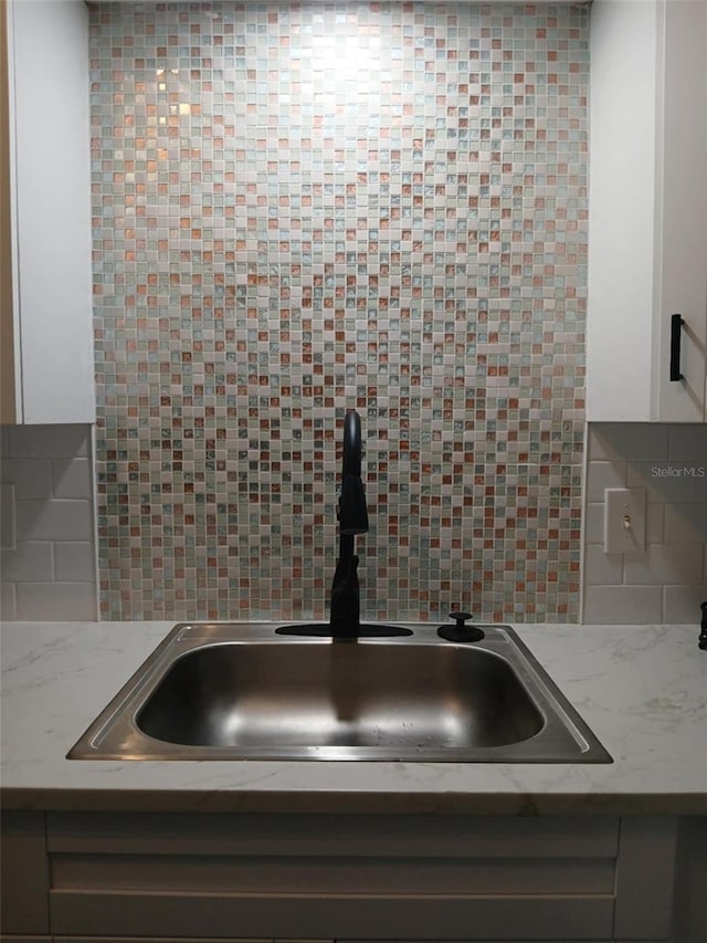 2257 World Parkway Blvd W Unit 61, Clearwater, FL 33763 - kitchen view of white cabinetry and backsplash