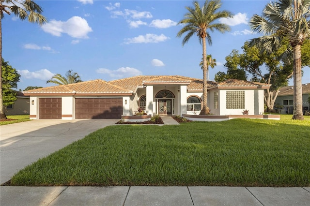 17032 Winners Cir, Odessa, FL 33556 - mediterranean / spanish-style home featuring stucco siding, an attached garage, a front yard, concrete driveway, and a tiled roof