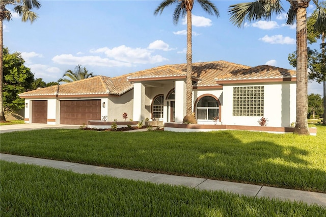 17032 Winners Cir, Odessa, FL 33556 - mediterranean / spanish-style house with a tiled roof, stucco siding, a garage, a front yard, and driveway