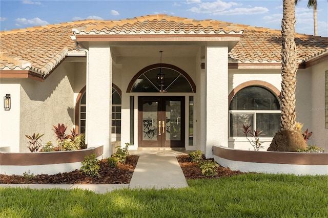 17032 Winners Cir, Odessa, FL 33556 - entrance to property with french doors, a tiled roof, and stucco siding