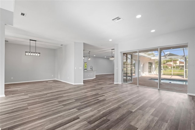17032 Winners Cir, Odessa, FL 33556 - unfurnished room featuring wood finished floors, healthy amount of natural light, and recessed lighting