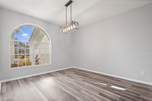 17032 Winners Cir, Odessa, FL 33556 - spare room with a chandelier and wood finished floors