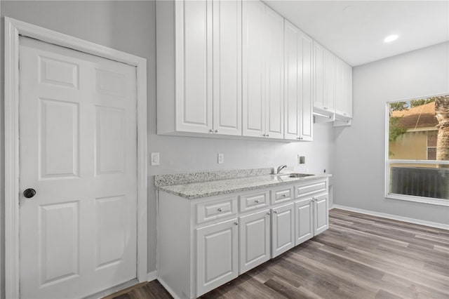 17032 Winners Cir, Odessa, FL 33556 - kitchen with white cabinetry, dark wood-style flooring, light stone countertops, and recessed lighting