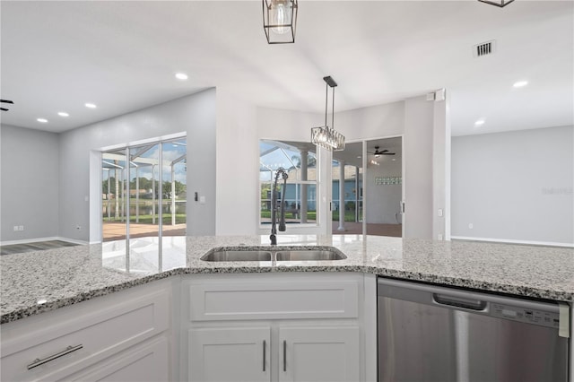 17032 Winners Cir, Odessa, FL 33556 - kitchen with stainless steel dishwasher, white cabinetry, ceiling fan, light stone counters, and recessed lighting