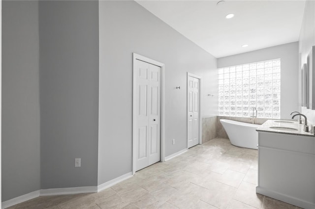 17032 Winners Cir, Odessa, FL 33556 - bathroom featuring a freestanding tub, vanity, and recessed lighting