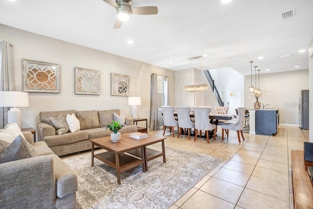 8901 Rhodes St, Kissimmee, FL 34747 - living room with light tile patterned floors, a ceiling fan, recessed lighting, and a chandelier