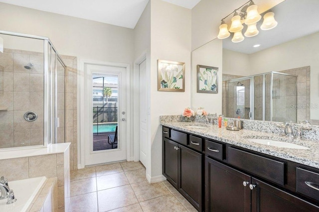 8901 Rhodes St, Kissimmee, FL 34747 - bathroom with a stall shower, double vanity, a bath, tile patterned flooring, and a chandelier
