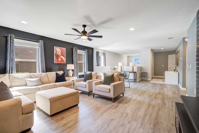 8901 Rhodes St, Kissimmee, FL 34747 - living area with ceiling fan, light wood finished floors, recessed lighting, and a textured ceiling