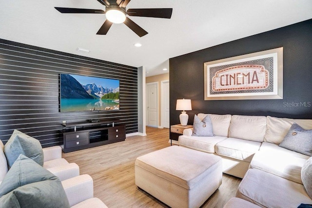 8901 Rhodes St, Kissimmee, FL 34747 - living room featuring an accent wall, ceiling fan, wood finished floors, and recessed lighting