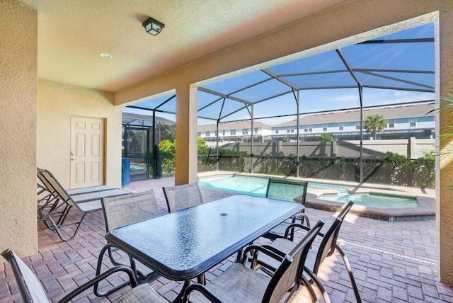 8901 Rhodes St, Kissimmee, FL 34747 - view of patio / terrace featuring glass enclosure and a pool with connected hot tub