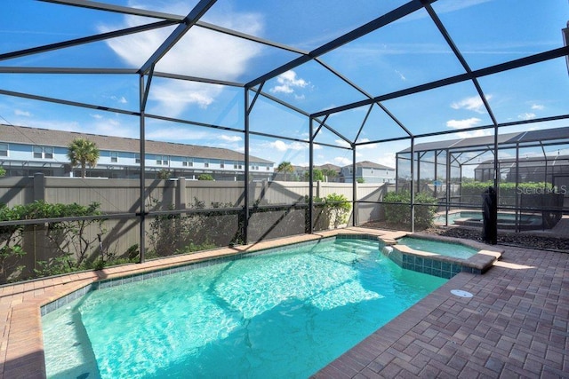 8901 Rhodes St, Kissimmee, FL 34747 - view of pool featuring a patio, a pool with connected hot tub, and glass enclosure