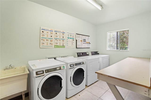 2850 N Powers Dr Unit 74, Orlando, FL 32818 - communal laundry room with separate washer and dryer and light tile patterned floors